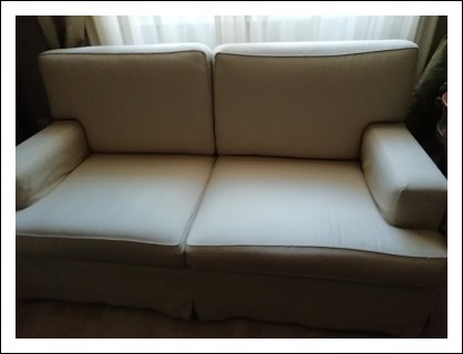 Two-seater textile sofa.